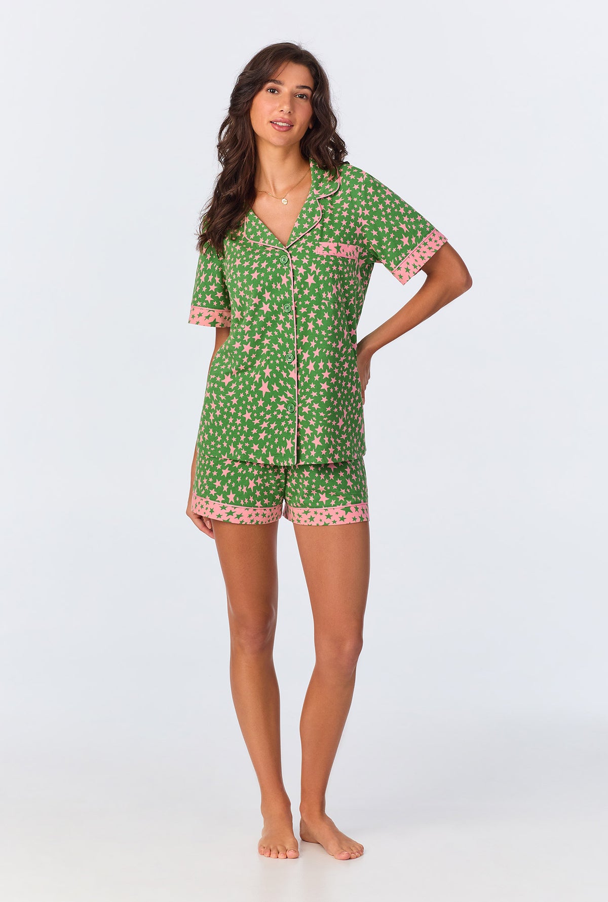 A lady wearing green short sleeve pajama set with green starlight print.