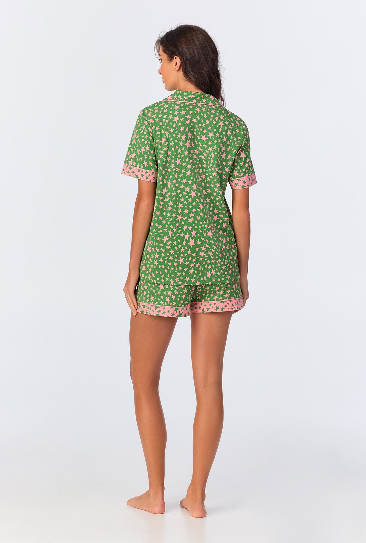 A lady wearing green short sleeve pajama set with green starlight print.