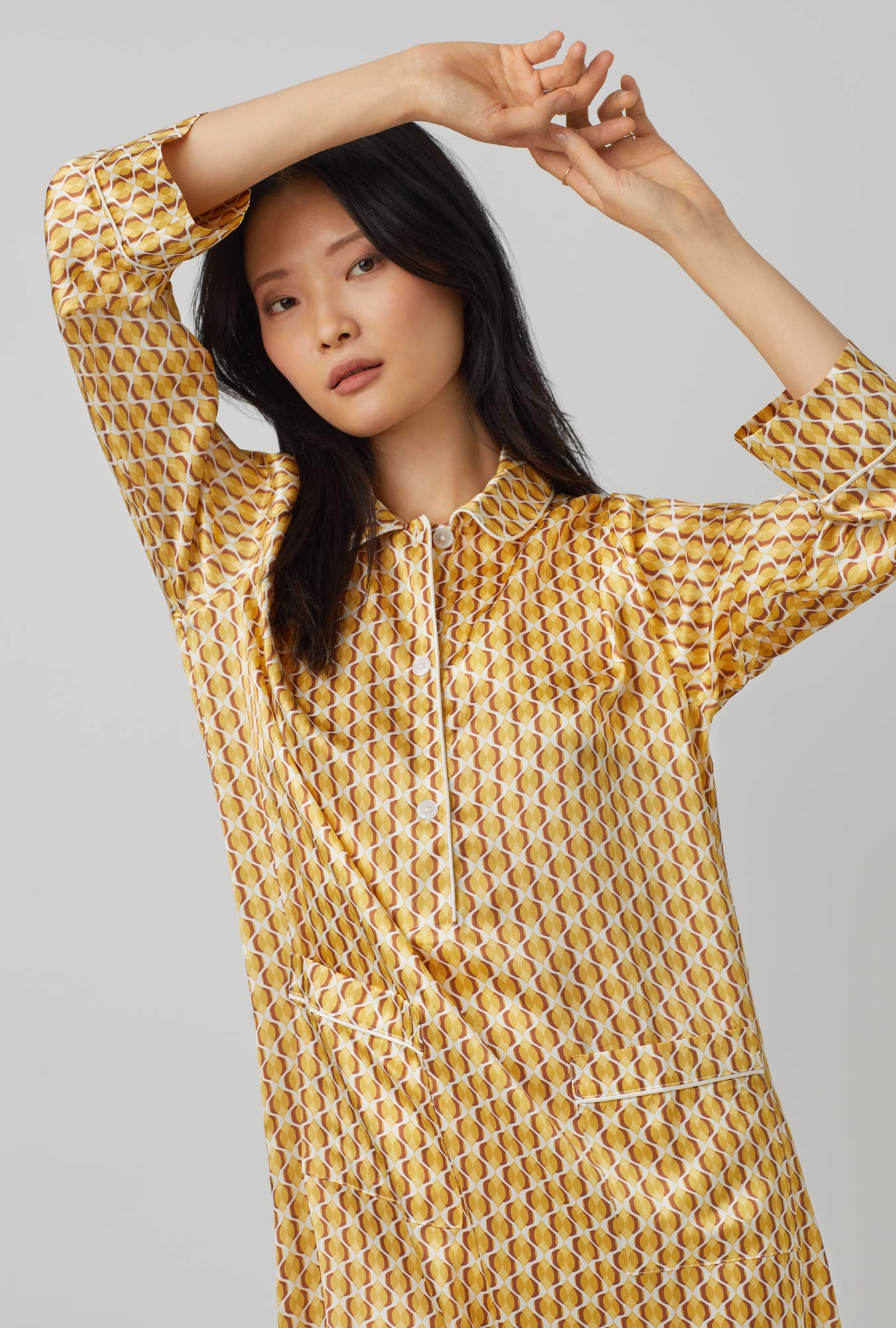 A lady wearing yellow Maxi Half Button Washable Silk Sleepshirt with Prize Geo print