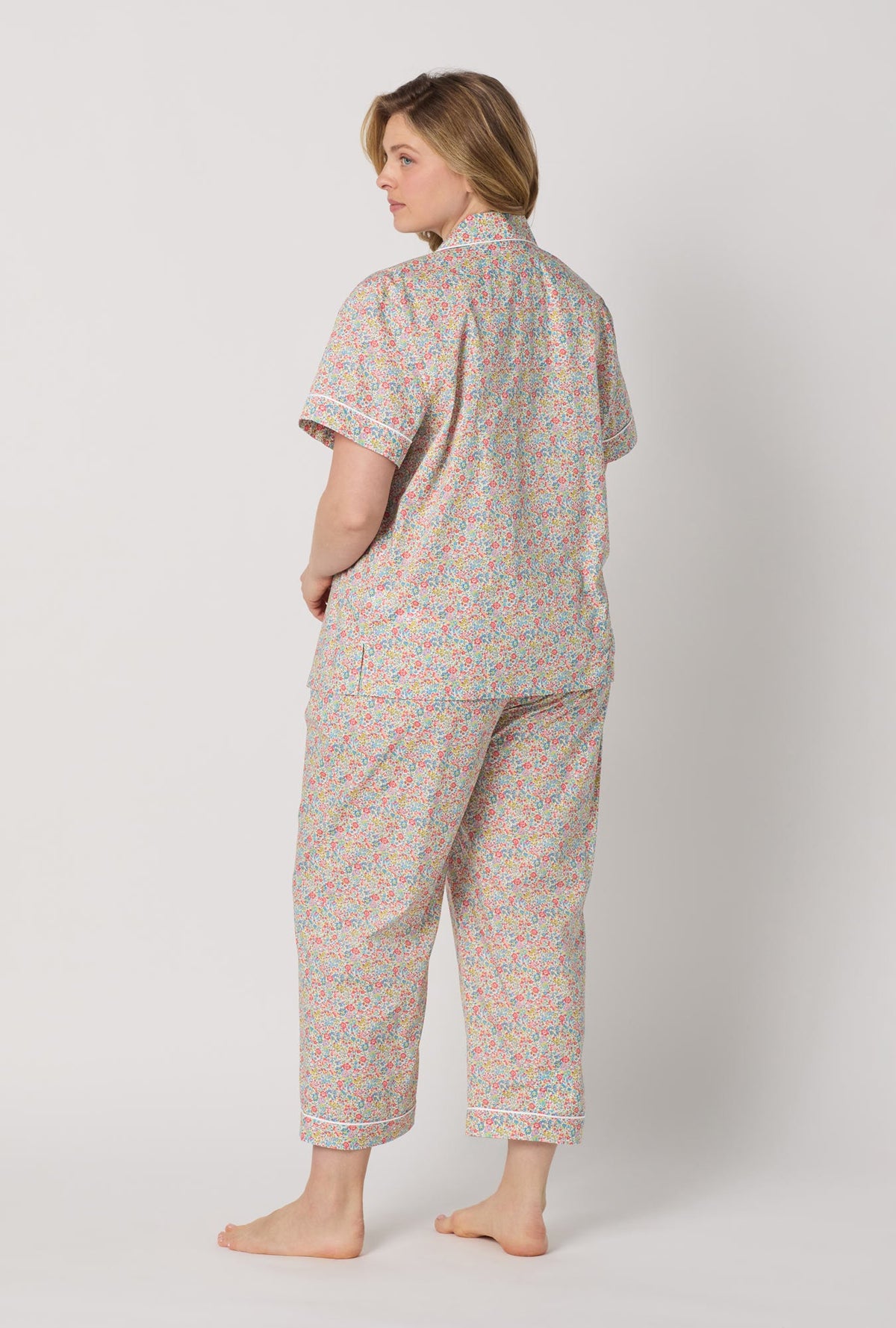 A lady wearing plus size Emma & Georgina Short Sleeve Classic Woven Tana Lawn® Cropped Pj Set Made With Liberty Fabric back view