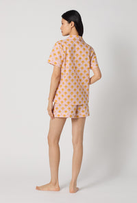 A Lady Wearing Deco Sunset Short Sleeve Classic Woven Cotton Poplin Shorty Pj Set showing back view