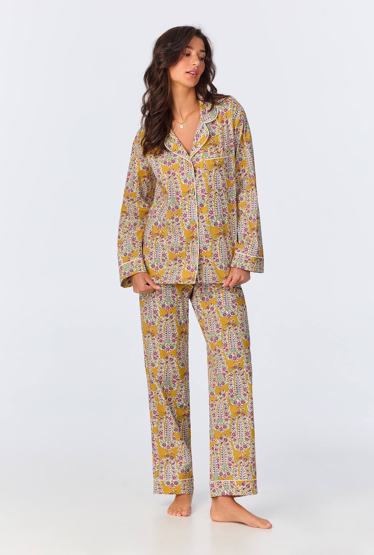 A lady wearing yellow long sleeve pajama set with budding blooms print.