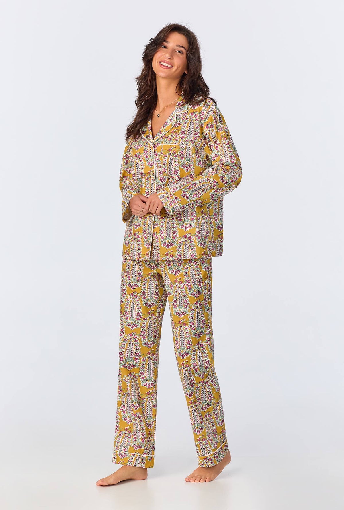 A lady wearing yellow long sleeve pajama set with budding blooms print.