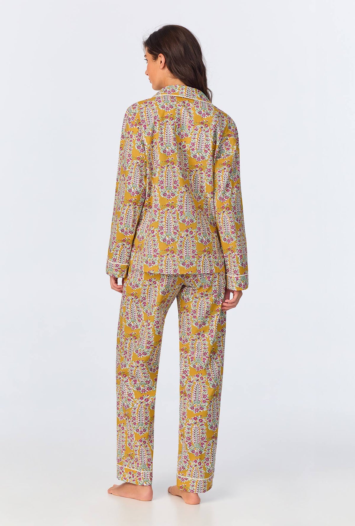 A lady wearing yellow long sleeve pajama set with budding blooms print.