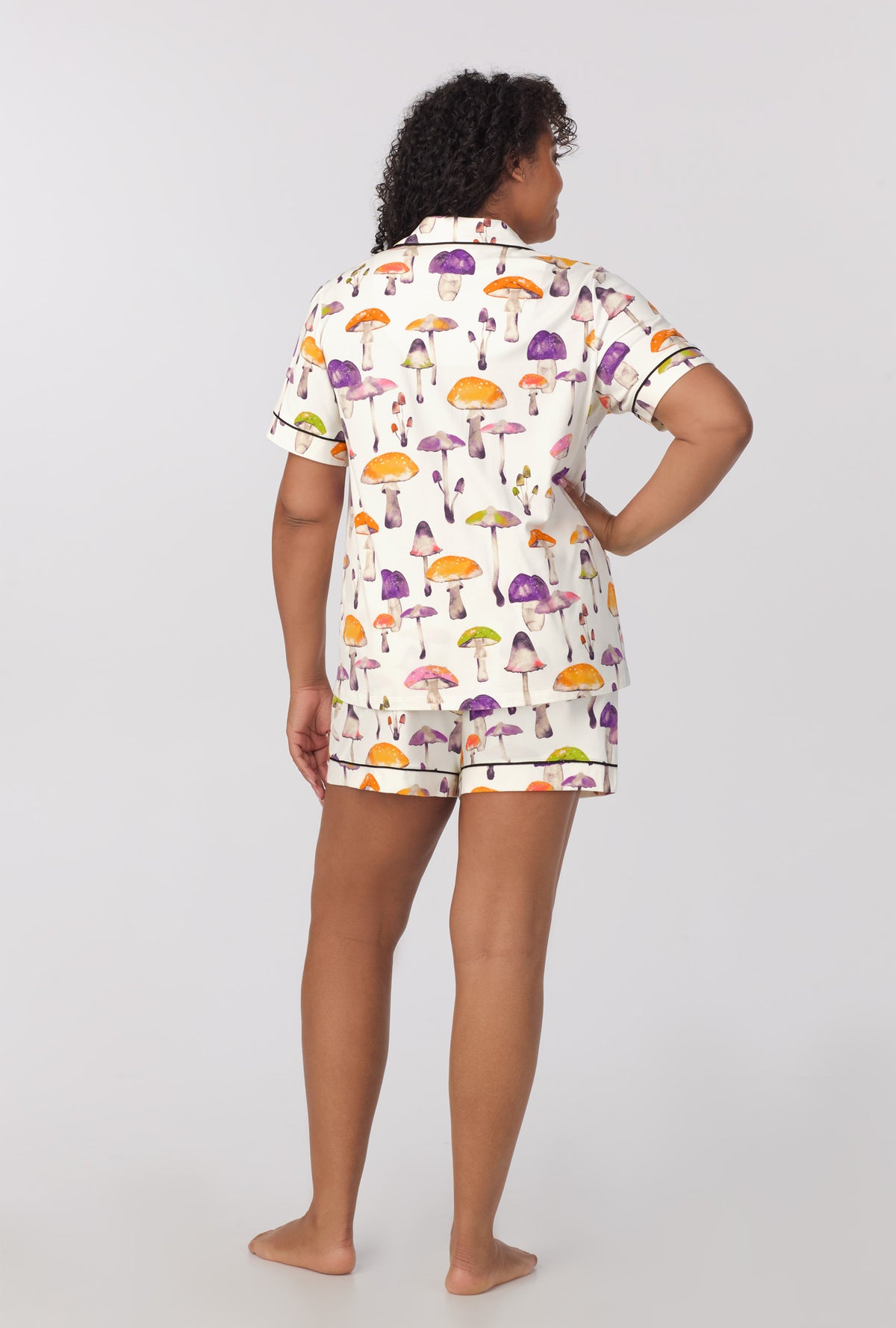 A lady wearing plus size Short Sleeve Classic Shorty Stretch Jersey PJ Set with Dazzling Mushrooms print 