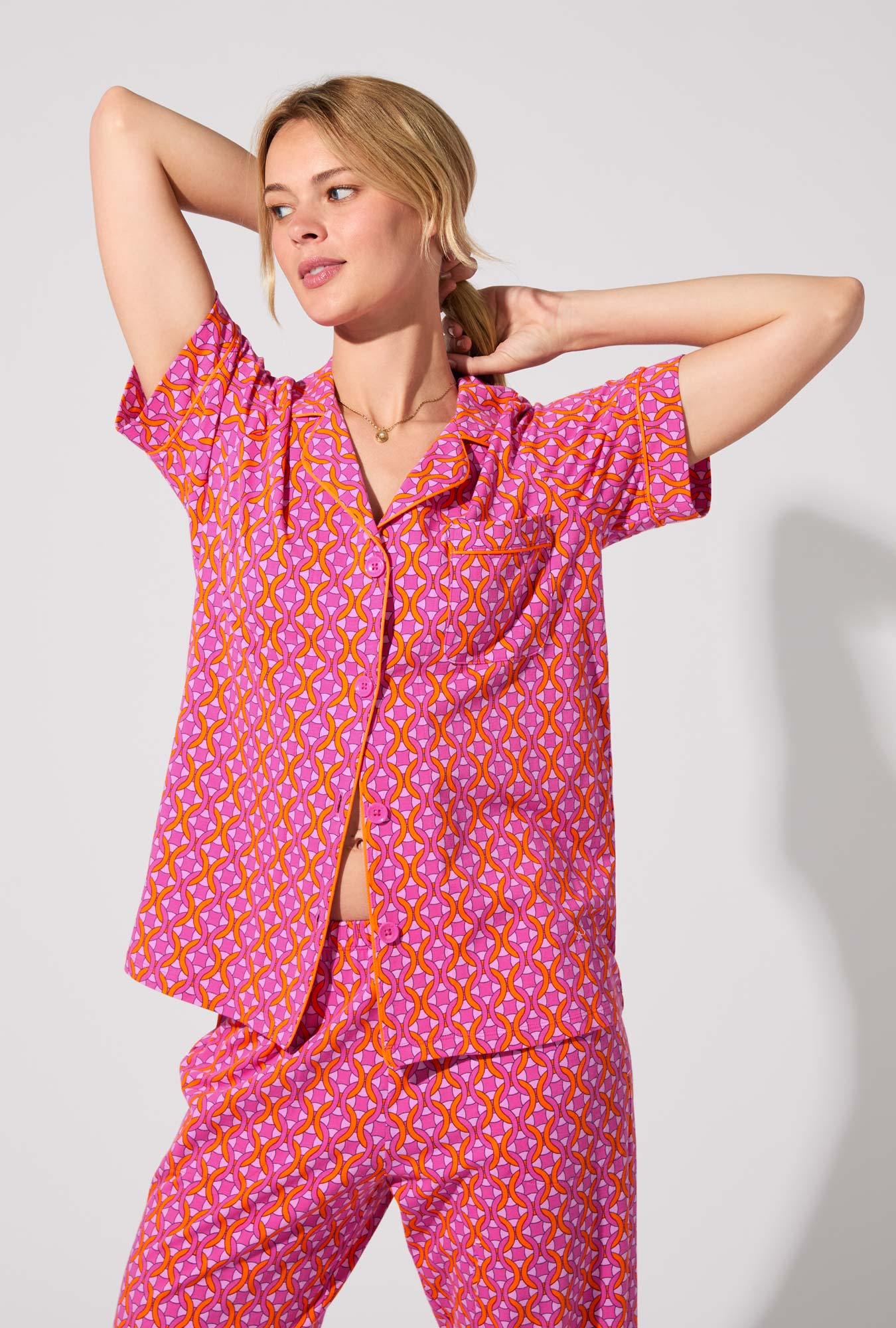 A lady wearing BedHead X Trina Turk Chain Geo Short Sleeve Classic Stretch Jersey Cropped PJ Set