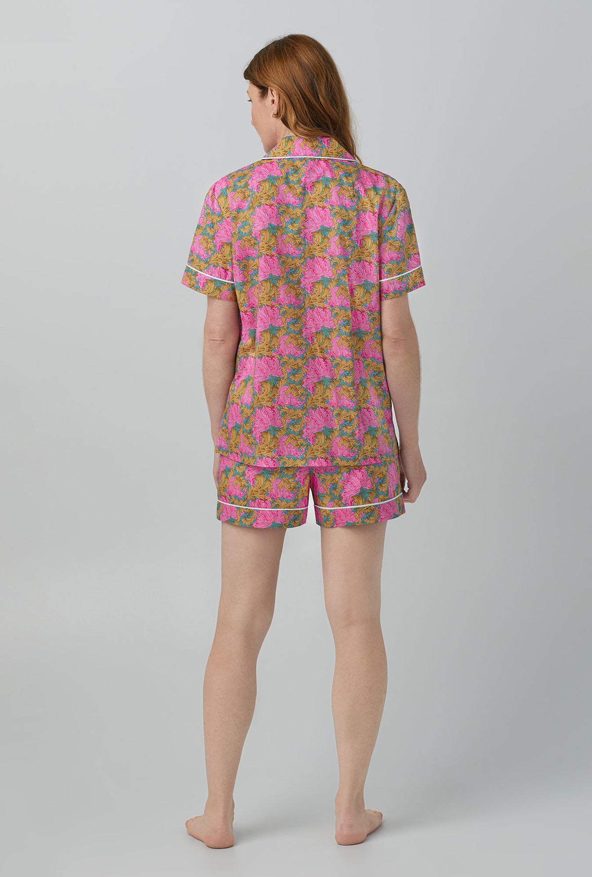A lady wearing Follow The Sun Short Sleeve Classic Woven Cotton Tana Lawn® Shorty PJ Set Made with Liberty Fabrics