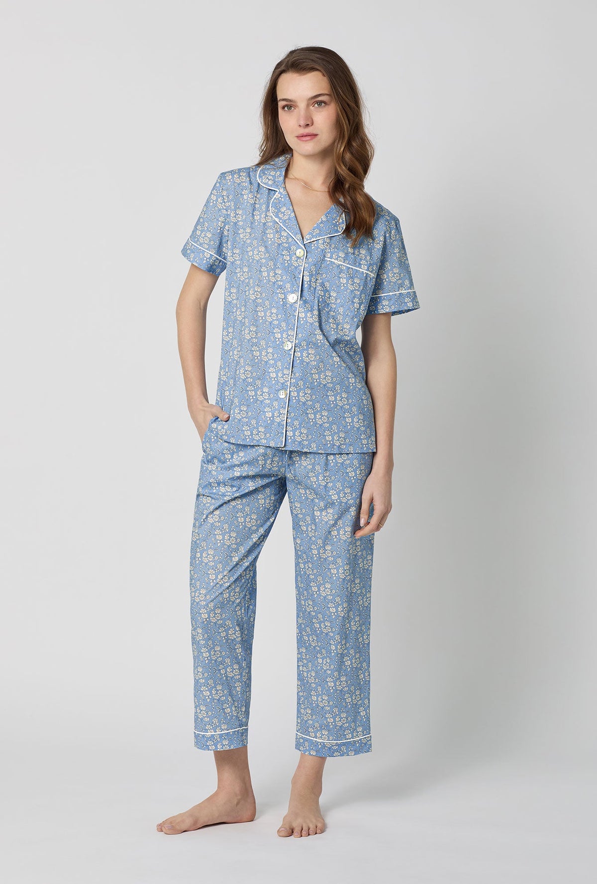 A lady wearing Blue Short Sleeve Classic Woven Tana Lawn® Cropped Pj Set Made With Liberty Fabric front view