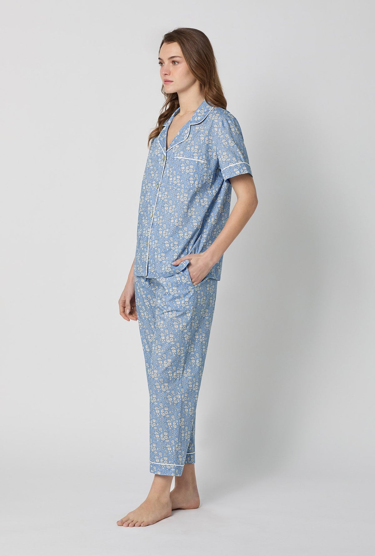 A lady wearing Blue Short Sleeve Classic Woven Tana Lawn® Cropped Pj Set Made With Liberty Fabric side view