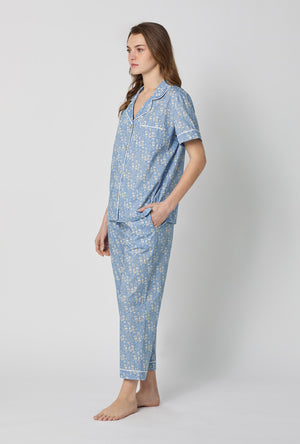 A lady wearing Blue Short Sleeve Classic Woven Tana Lawn® Cropped Pj Set Made With Liberty Fabric side view
