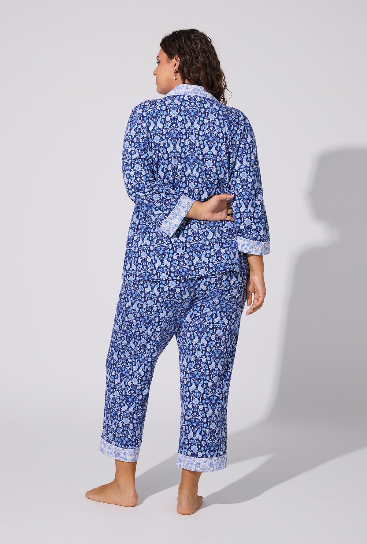 A lady wearing Bloomscape Blue 3/4 Sleeve Classic Stretch Jersey Cropped PJ Set