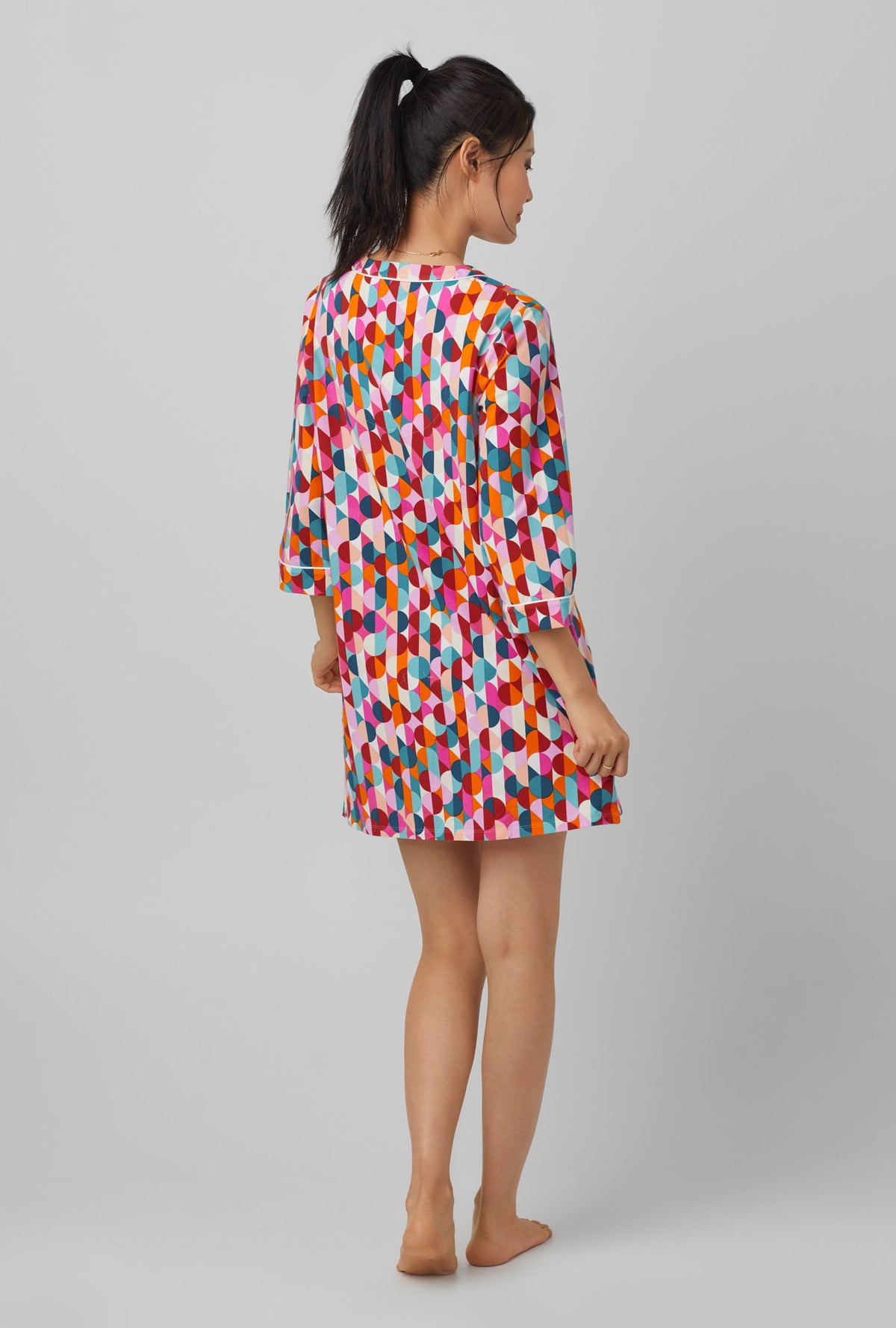 A lady wearing 3/4 Sleeve Stretch Jersey Sleepshirt with dancing dots print