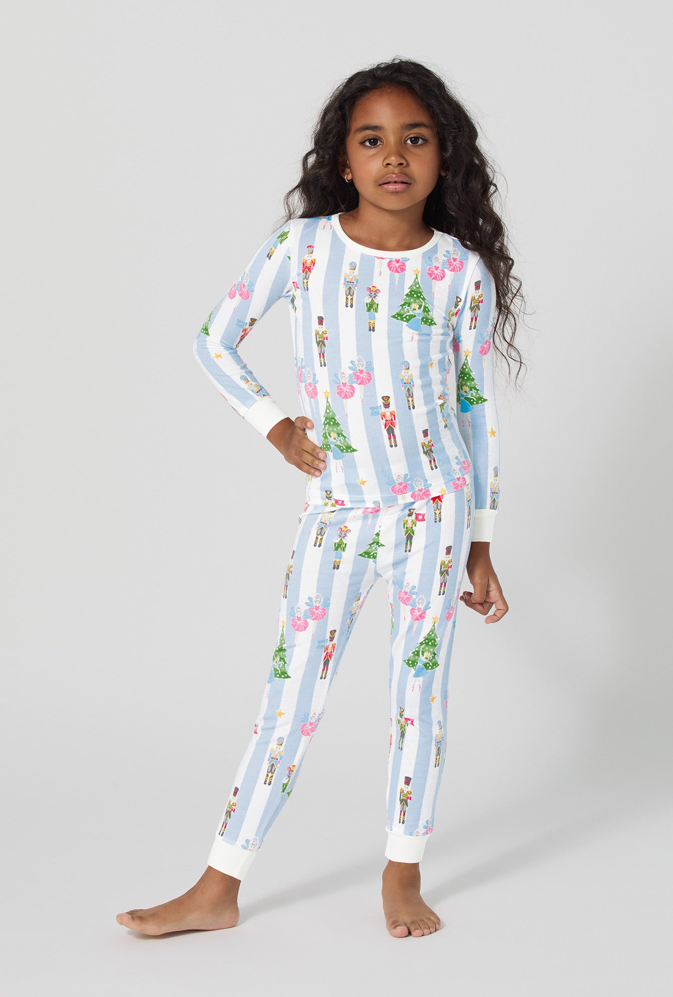 A girl wearing Sugarplum Stripe Long Sleeve Stretch Jersey Kids Pj Set