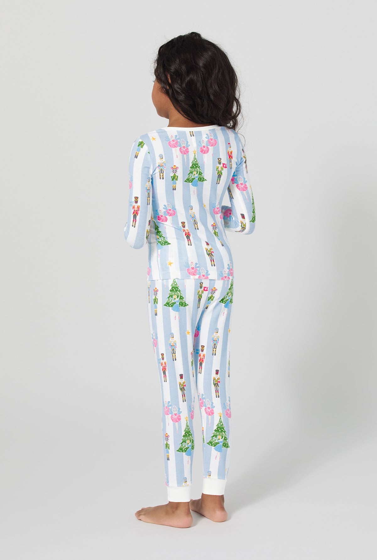 A girl wearing Sugarplum Stripe Long Sleeve Stretch Jersey Kids Pj Set