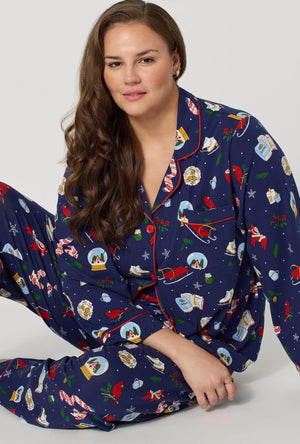 A lady wearing plus size Nordic Nights Long Sleeve Classic Stretch Jersey Pj Set sitting down