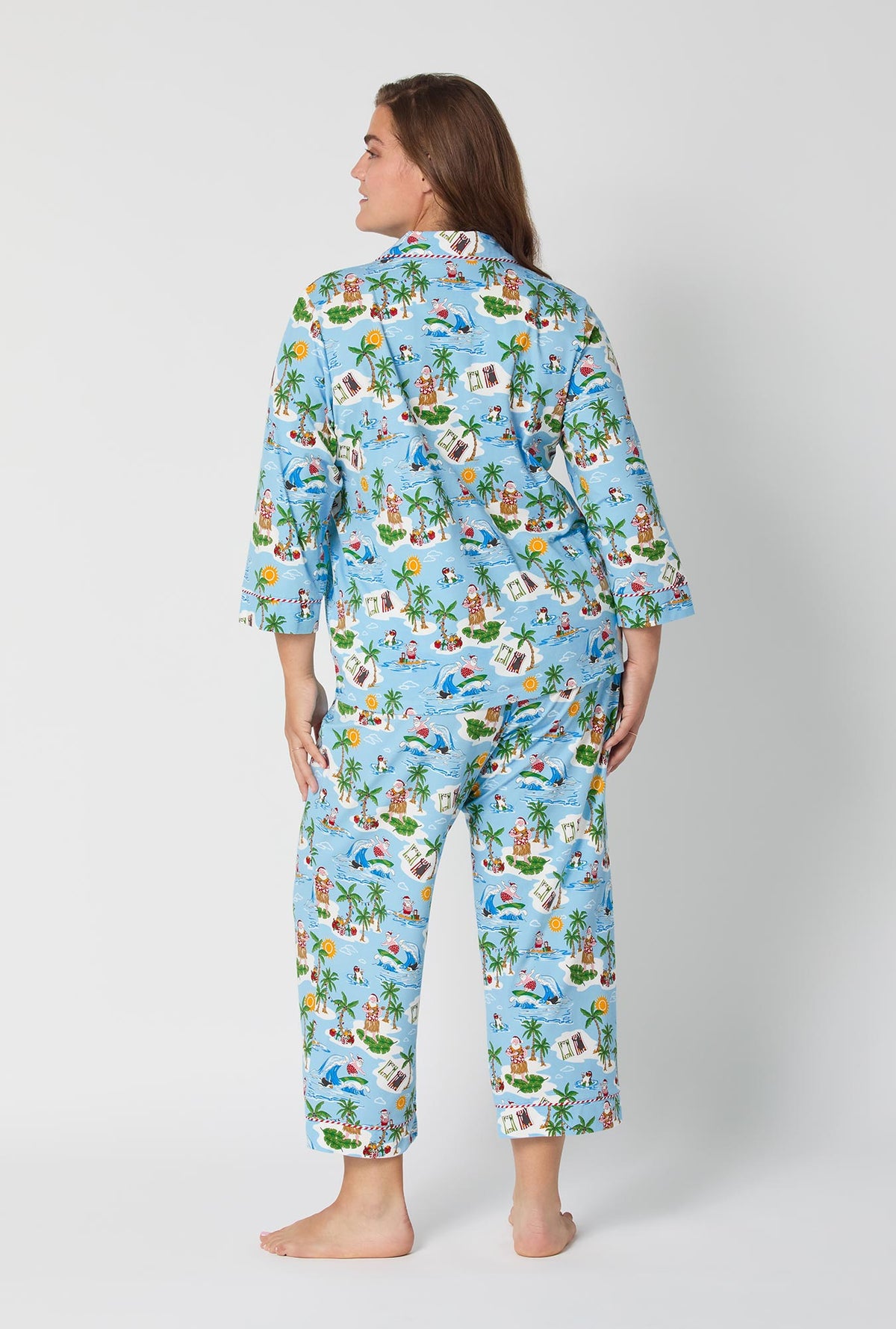 A lady wearing Surfin' Santa 3/4 Sleeve Classic Stretch Jersey Cropped Pj Set