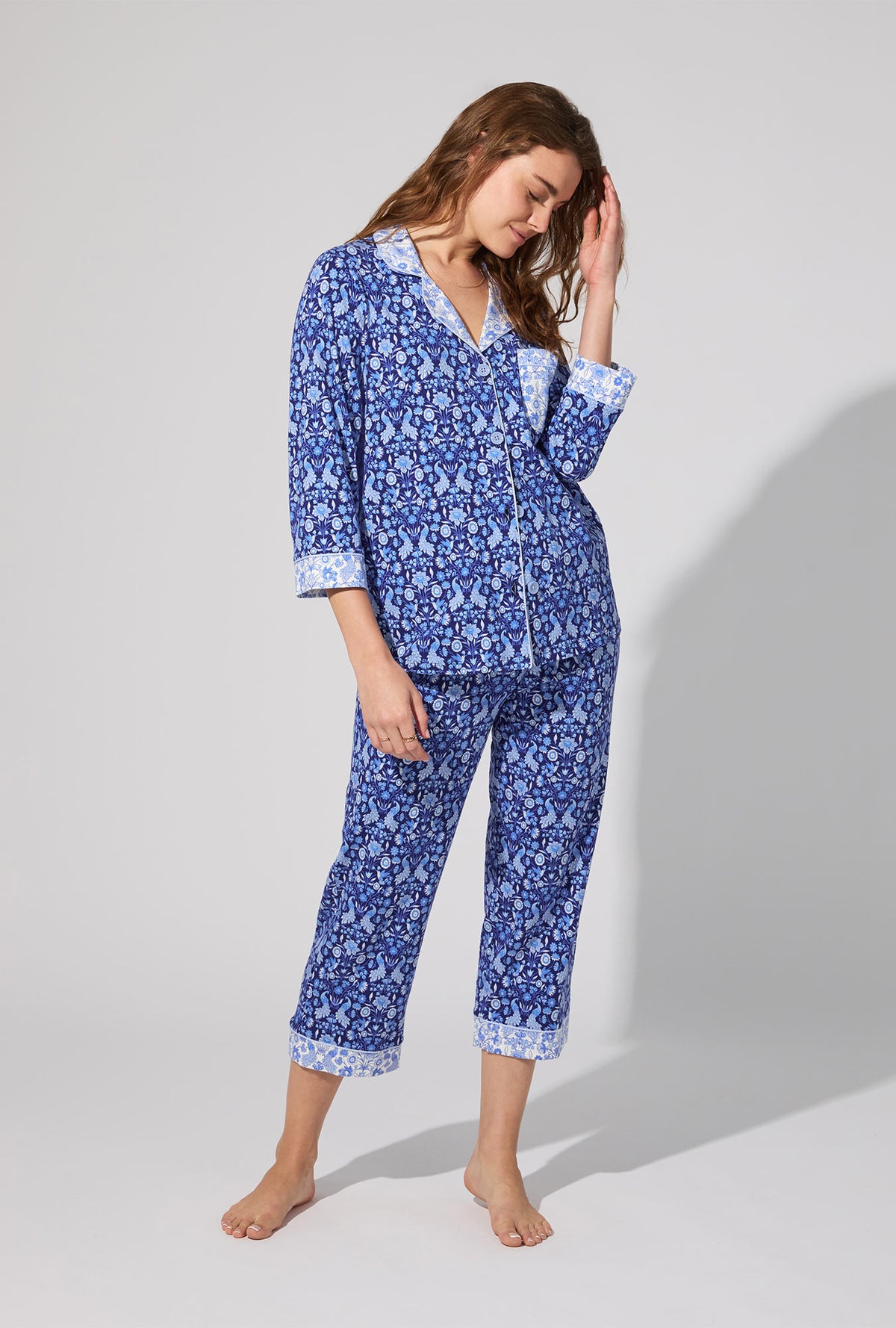 A lady wearing Bloomscape Blue 3/4 Sleeve Classic Stretch Jersey Cropped PJ Set