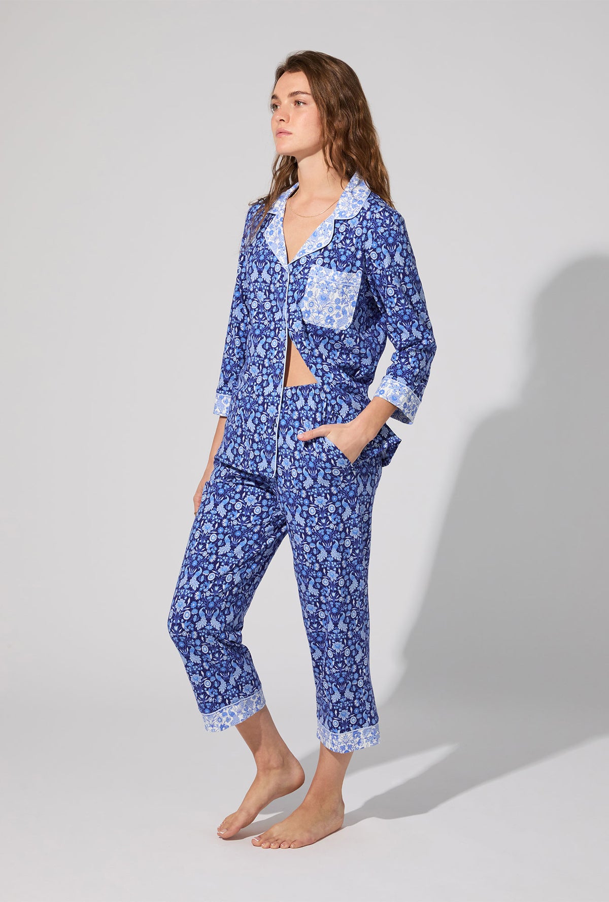 A lady wearing Bloomscape Blue 3/4 Sleeve Classic Stretch Jersey Cropped PJ Set
