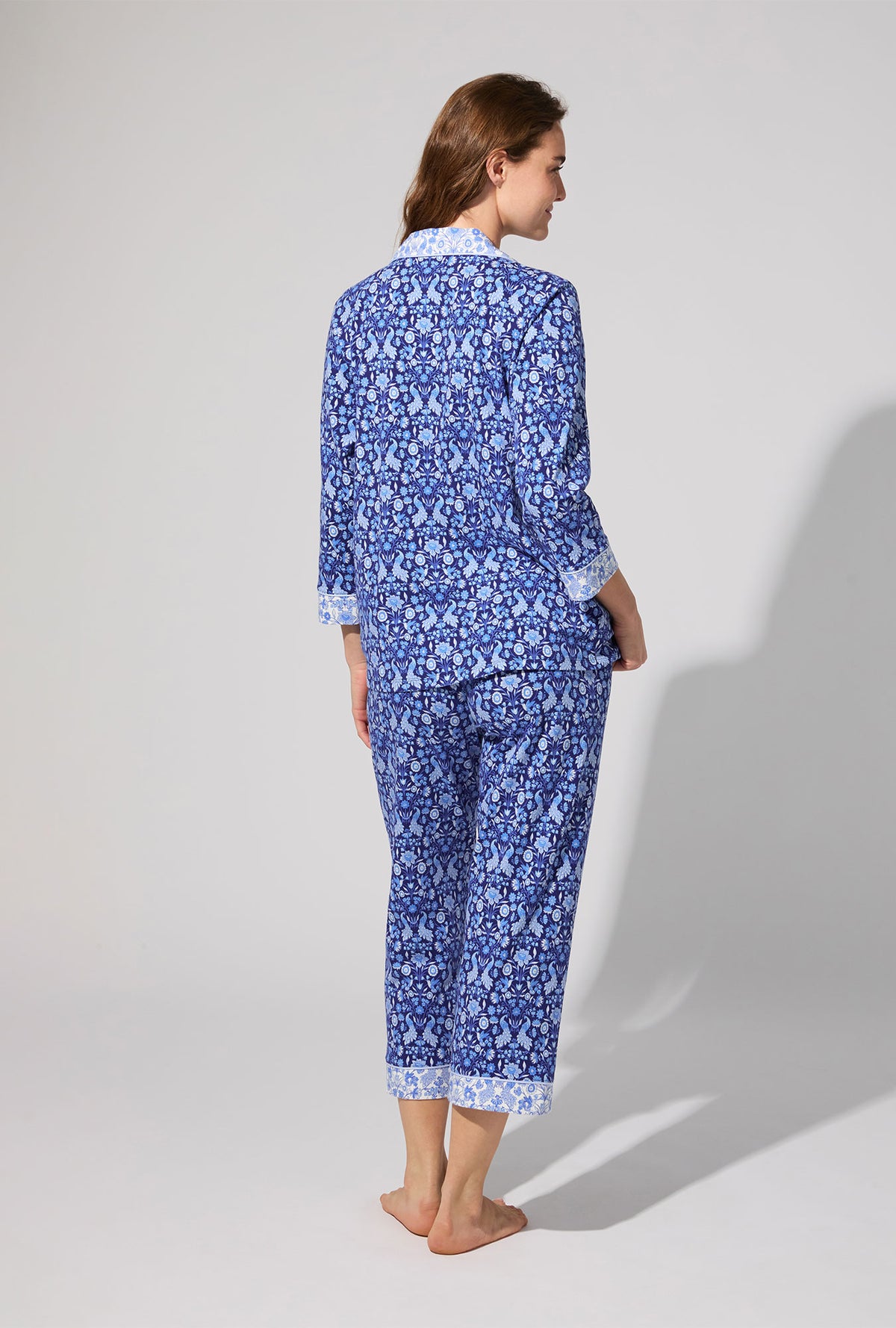 A lady wearing Bloomscape Blue 3/4 Sleeve Classic Stretch Jersey Cropped PJ Set