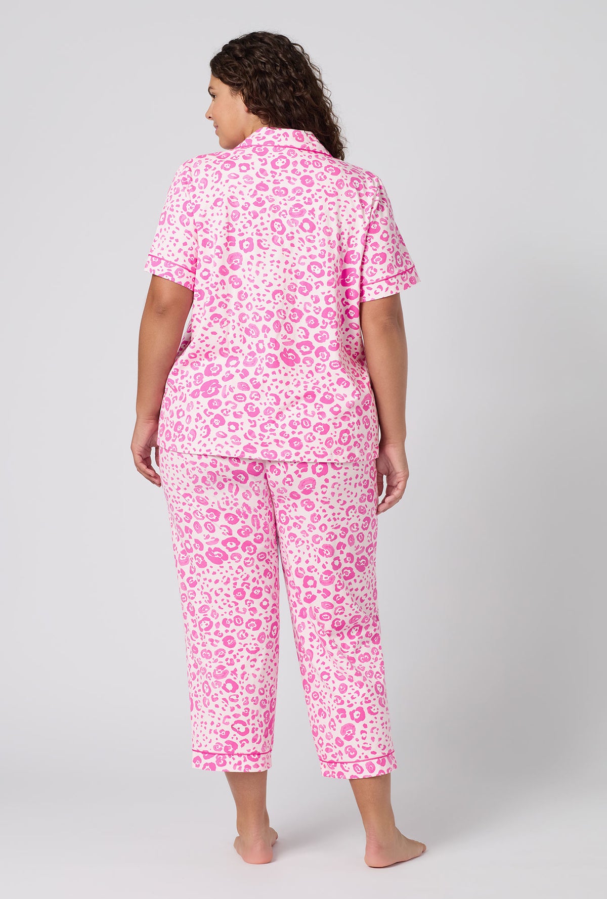 A Lady Wearing Plus Size Valentina Leopard Short Sleeve Classic Stretch Jersey Cropped Pj Set in a back view pose