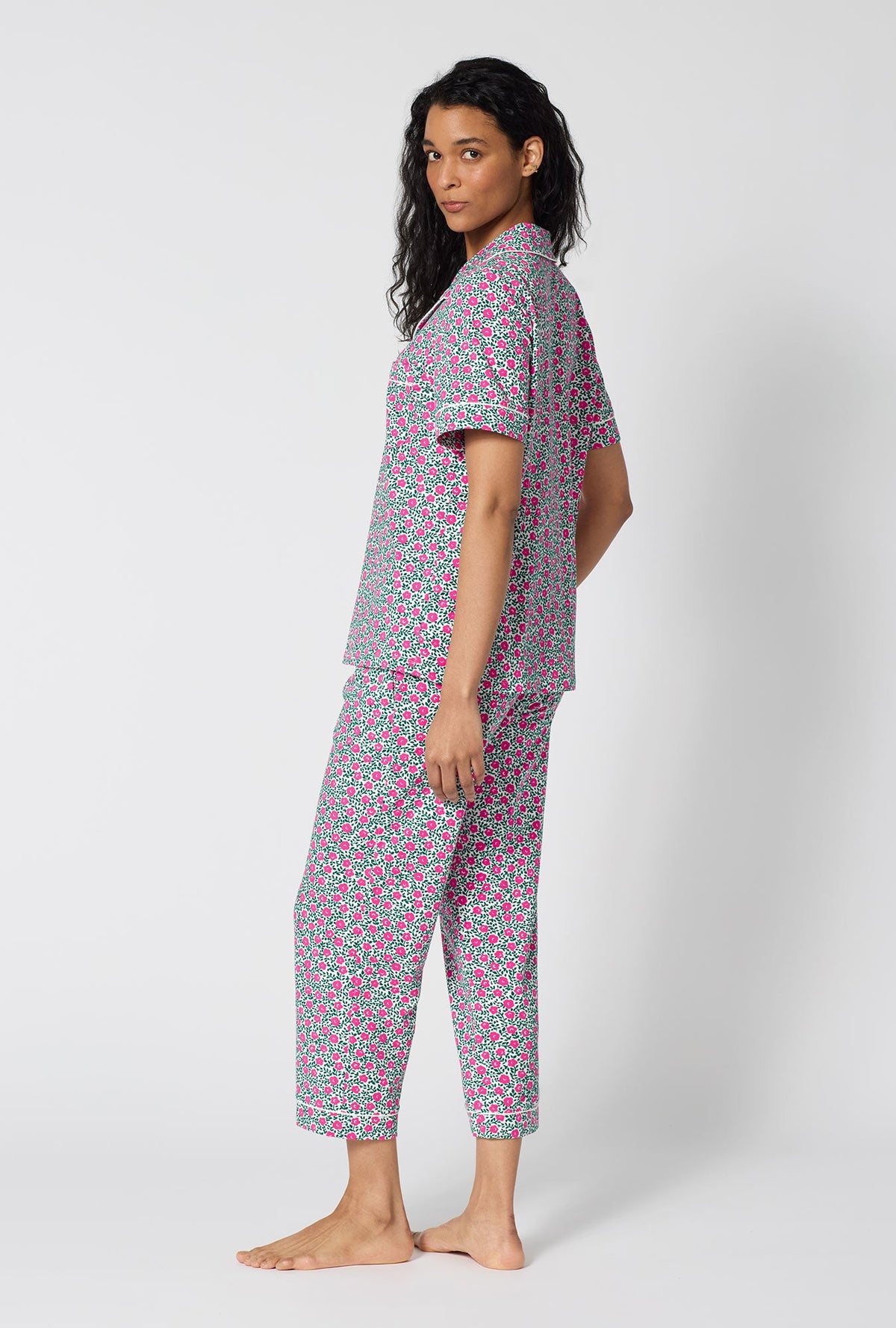 A Lady Wearing  Petite Petunias Short Sleeve Classic Stretch Jersey Cropped Pj Set in a back view pose