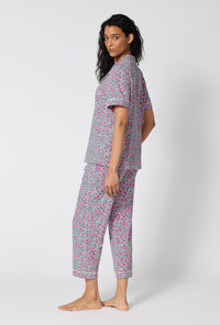 A Lady Wearing  Petite Petunias Short Sleeve Classic Stretch Jersey Cropped Pj Set in a back view pose