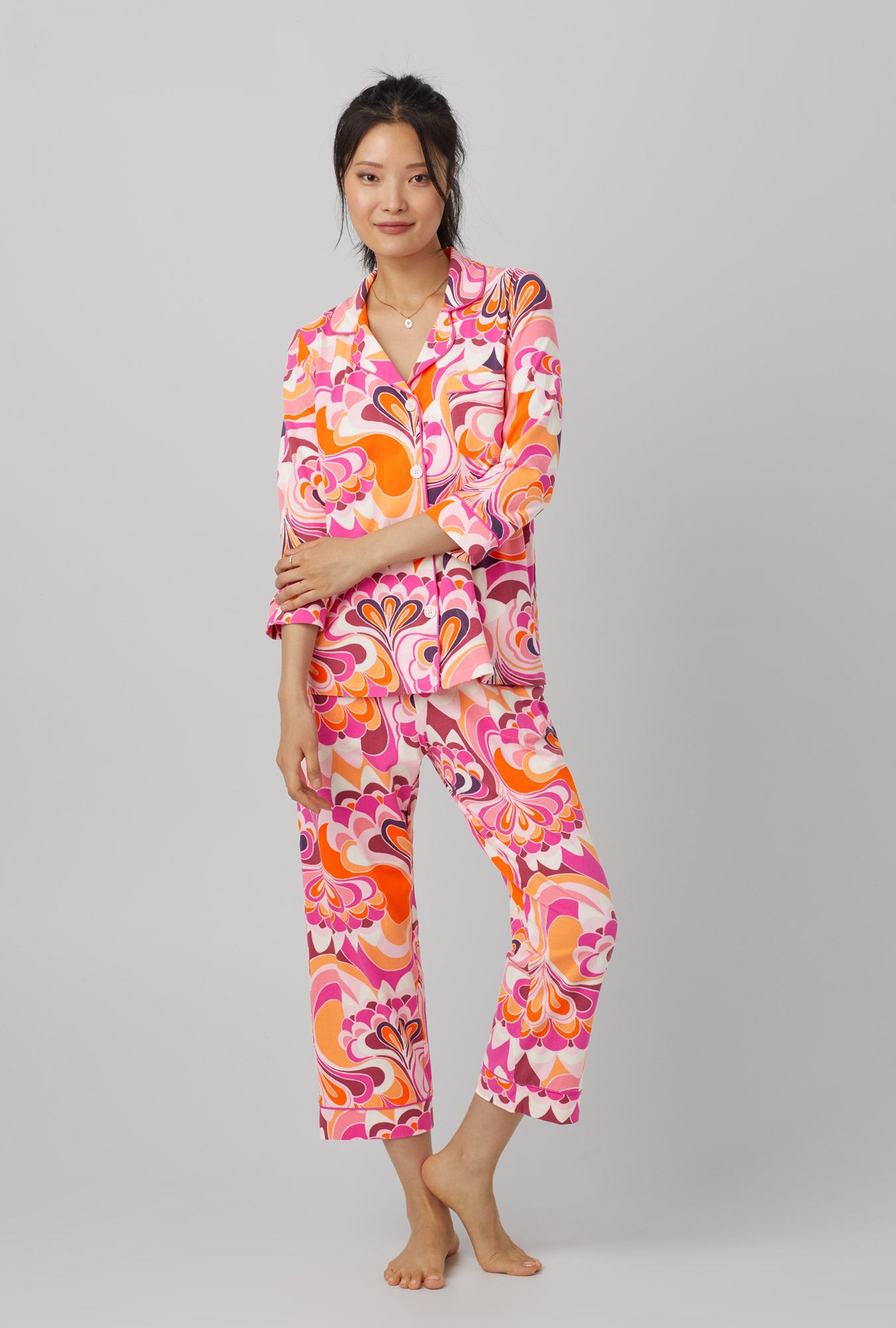 A lady wearing pink quarter sleeve classic stretch jersey cropped pj set with trina turk lotus print. 