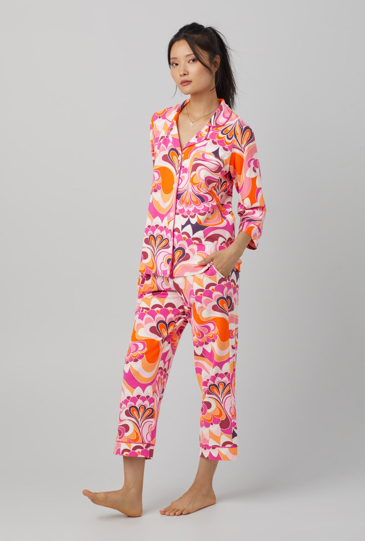 A lady wearing pink quarter sleeve classic stretch jersey cropped pj set with trina turk lotus print. 