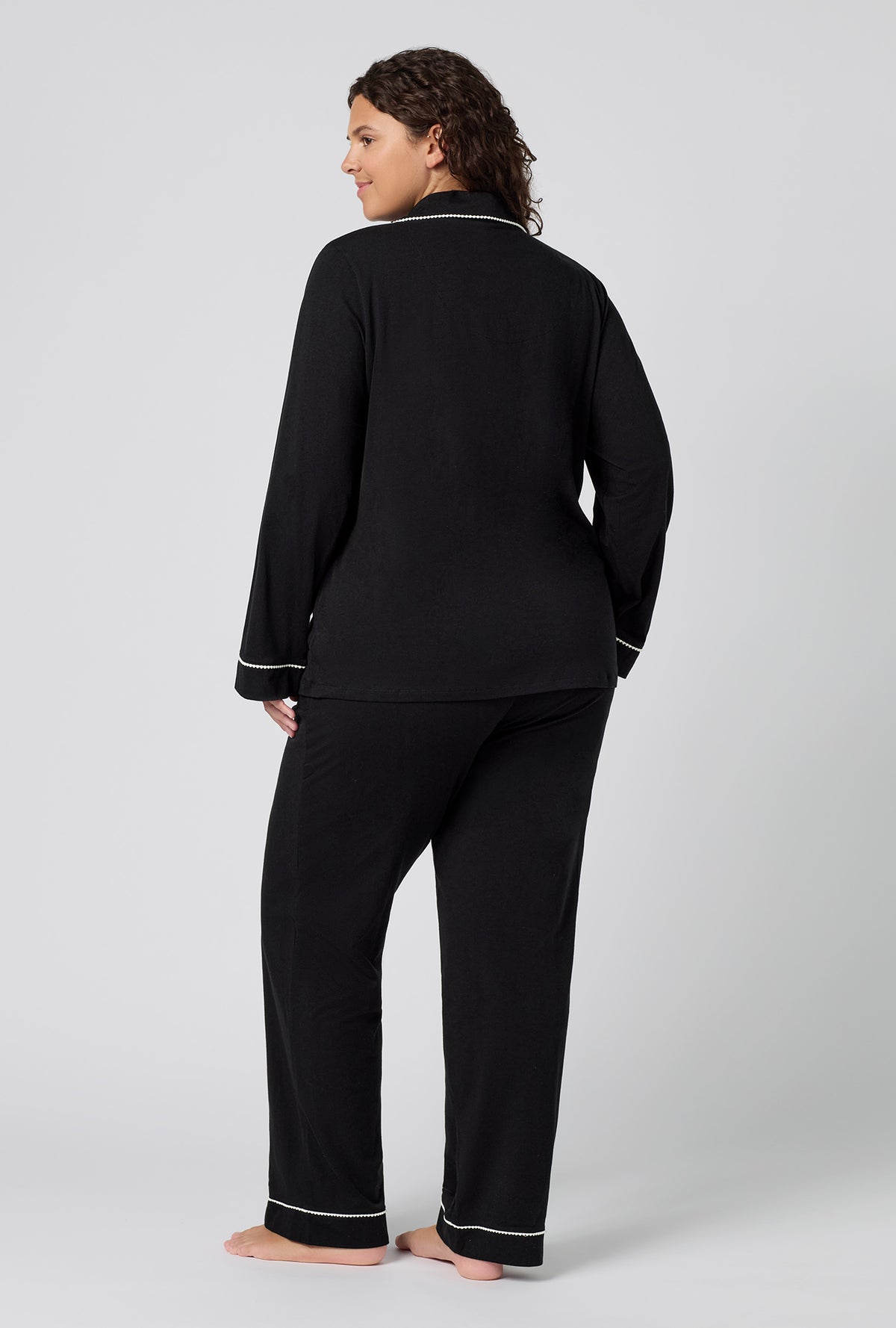A lady wearing plus size Black Beauty Long Sleeve Classic Stretch Jersey Pj Set back view