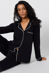 A lady wearing Black Beauty Long Sleeve Classic Stretch Jersey Pj Set sitting down
