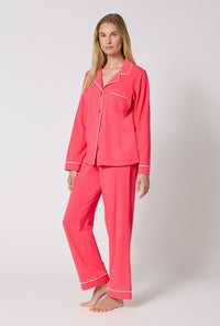 A lady wearing Coral Red Long Sleeve Classic Stretch Jersey Pj Set