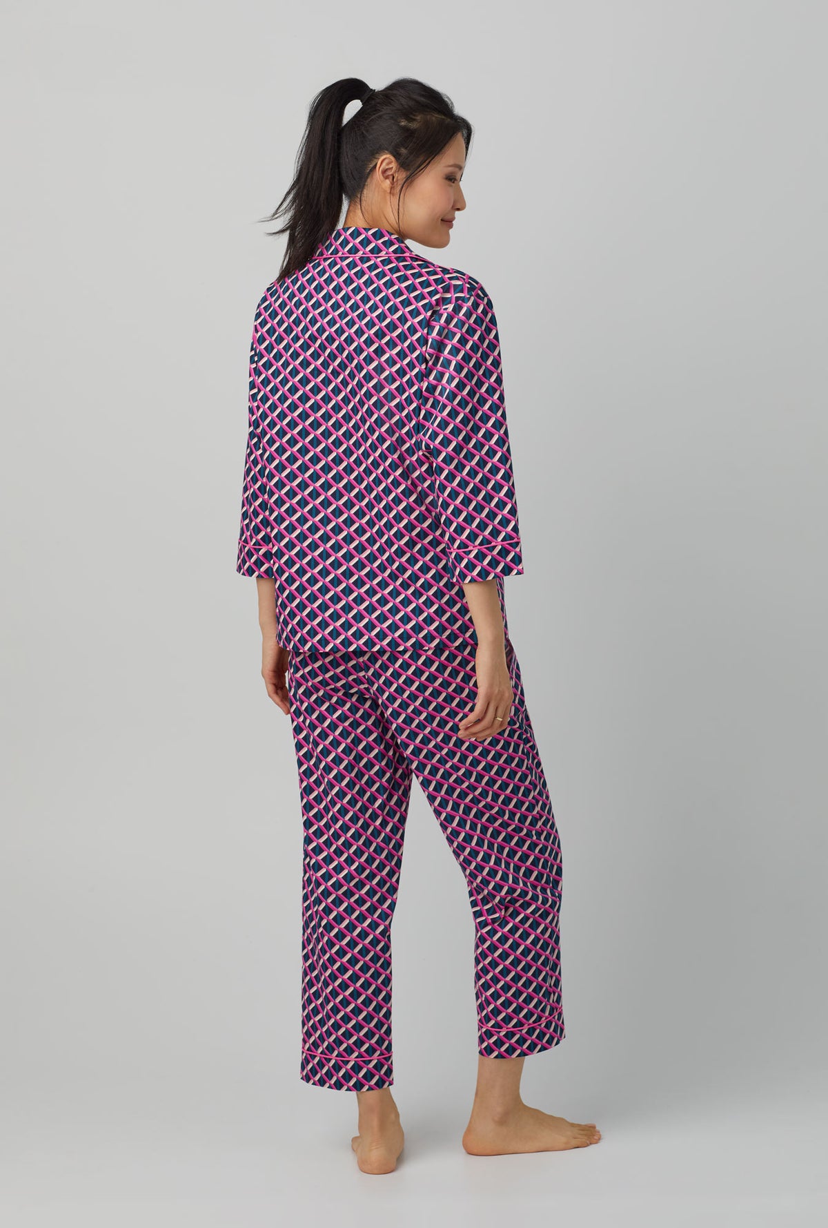 A lady wearing quarter sleeve classic woven cotton poplin cropped pj set with trina turk lattice geo print.