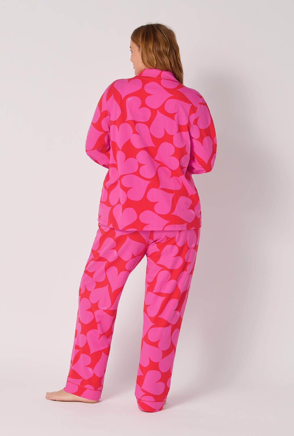 A lady wearing BedHead x Trina Turk Hearts Long Sleeve Classic Stretch Jersey Pj Set
