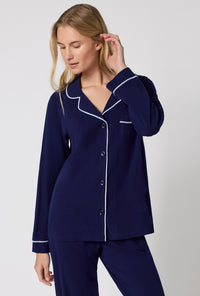 A lady wearing Midnight Navy Long Sleeve Classic Stretch Jersey Pj Set looking down