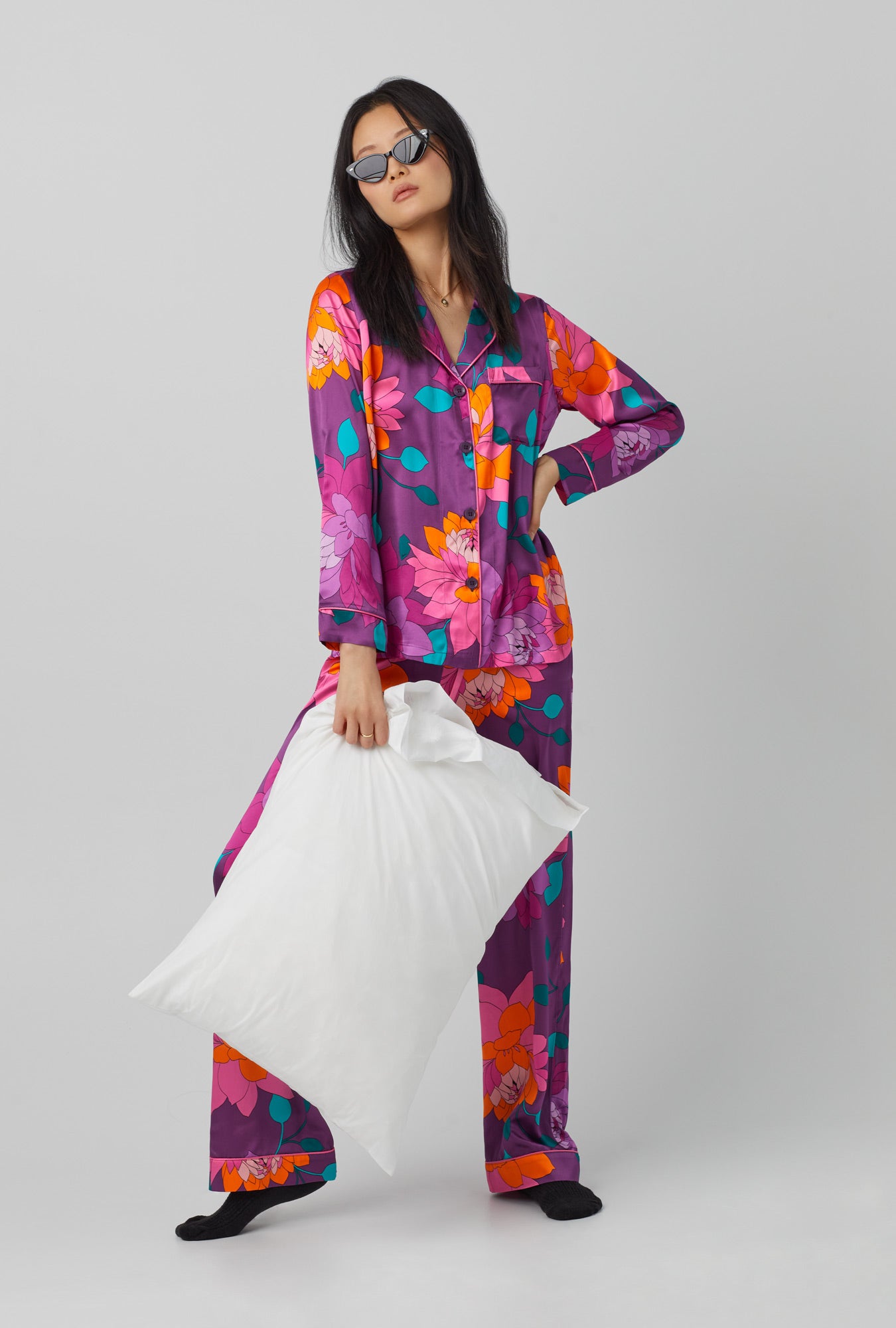 A lady wearing purple long sleeve classic washable silk pj set with trina turk evening blooms print.