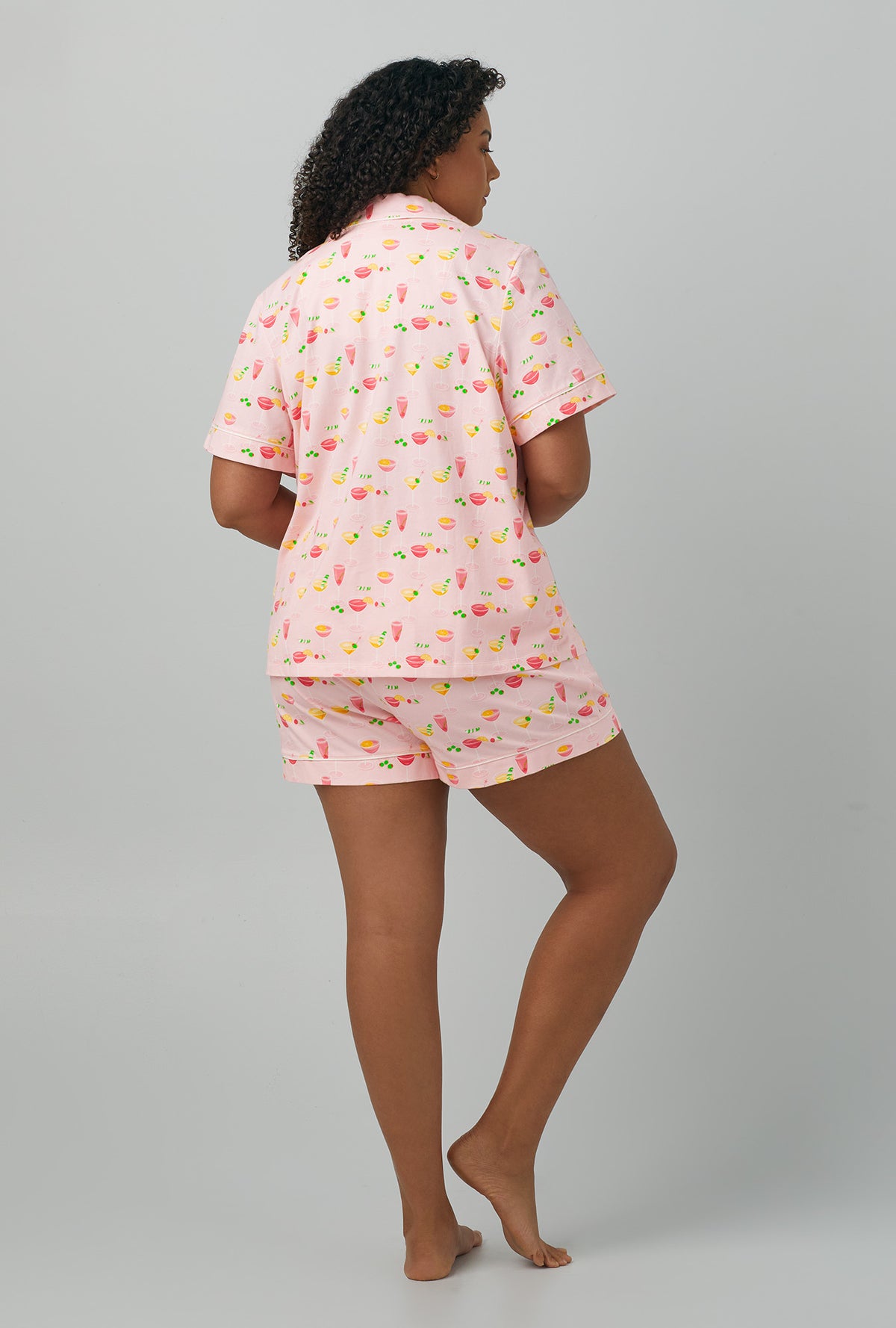 A lady wearing plus size pink Short Sleeve Classic Shorty Stretch Jersey PJ Set with Pink Mixology print
