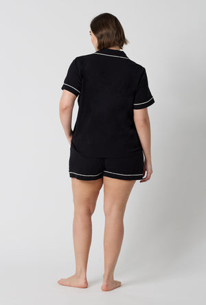 A lady wearing plus size Black Beauty Short Sleeve Classic Shorty Stretch Jersey Pj Set back view