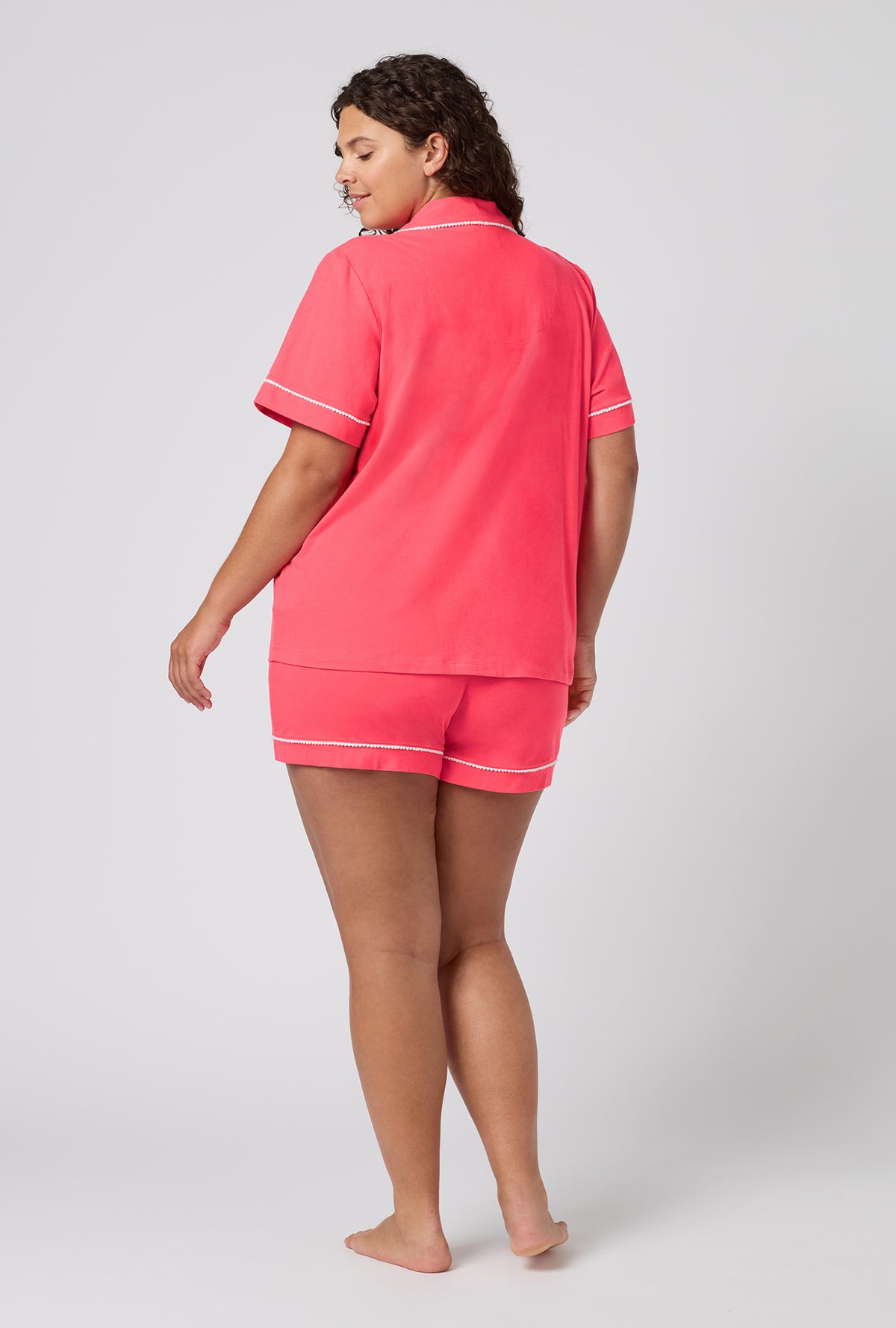 A lady wearing plus size Coral Red Short Sleeve Classic Shorty Stretch Jersey Pj Set back view