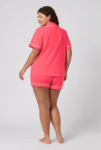 A lady wearing plus size Coral Red Short Sleeve Classic Shorty Stretch Jersey Pj Set back view