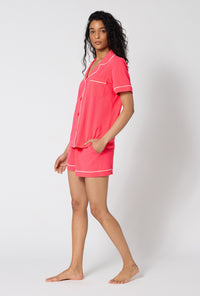 A lady wearing Coral Red Short Sleeve Classic Shorty Stretch Jersey Pj Set side view