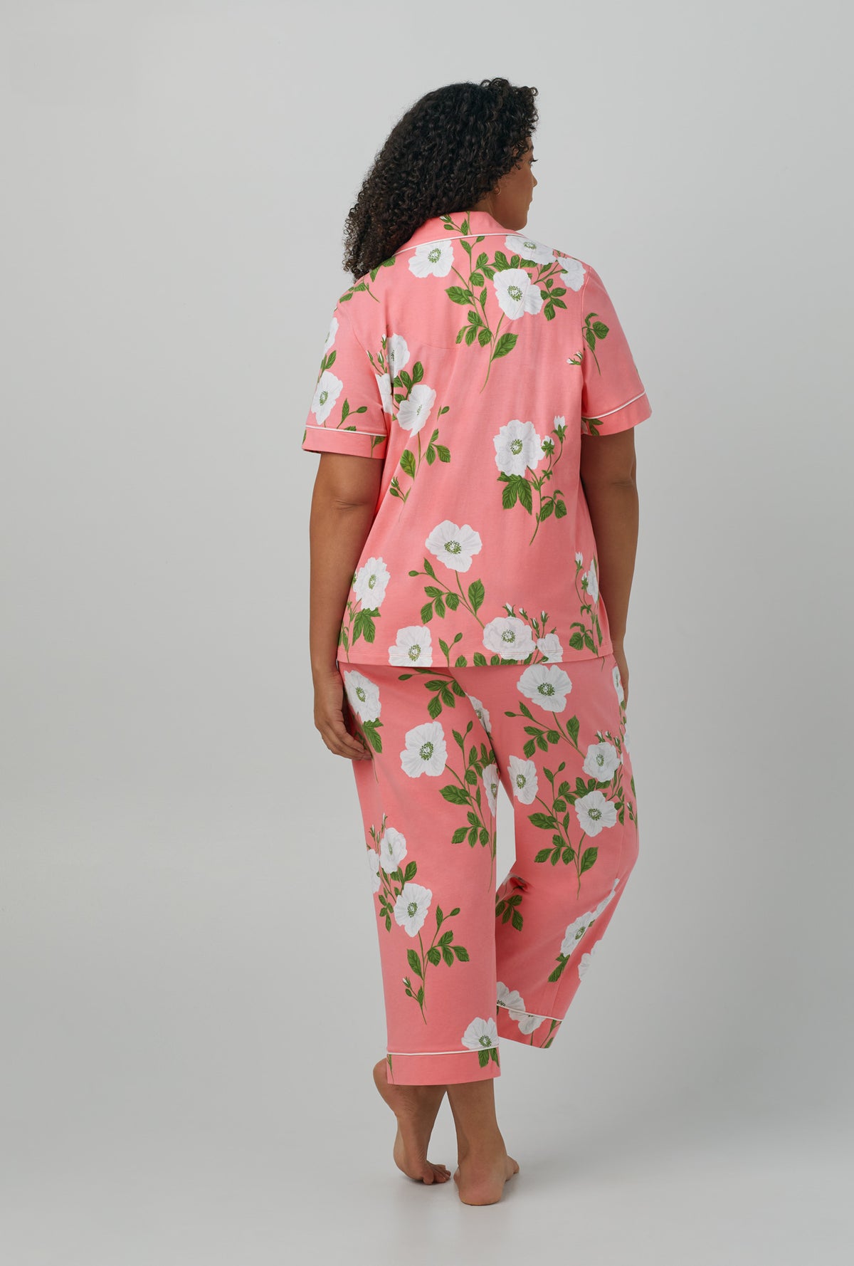 A lady wearing plus size red Short Sleeve Classic Stretch Jersey Cropped PJ Set with White Poppy print