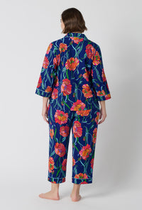 A Lady Wearing Plus Size BedHead x Trina Turk Linear Poppy 3/4 Sleeve Classic Stretch Jersey Cropped Pj Set in a back view pose