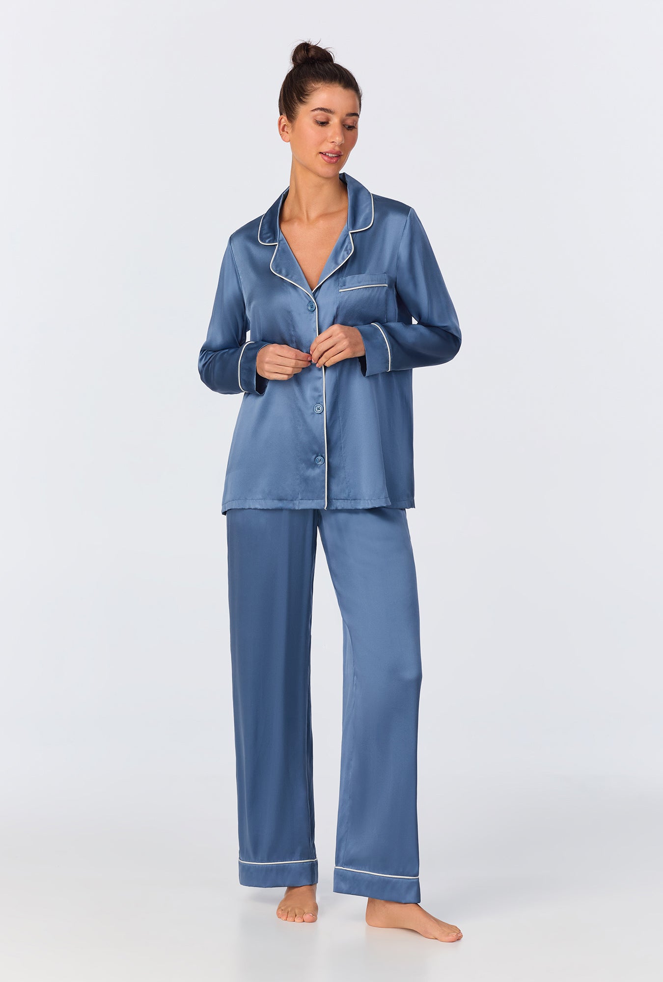 A lady wearing Elemental Blue Long Sleeve Classic Washable Silk PJ Set