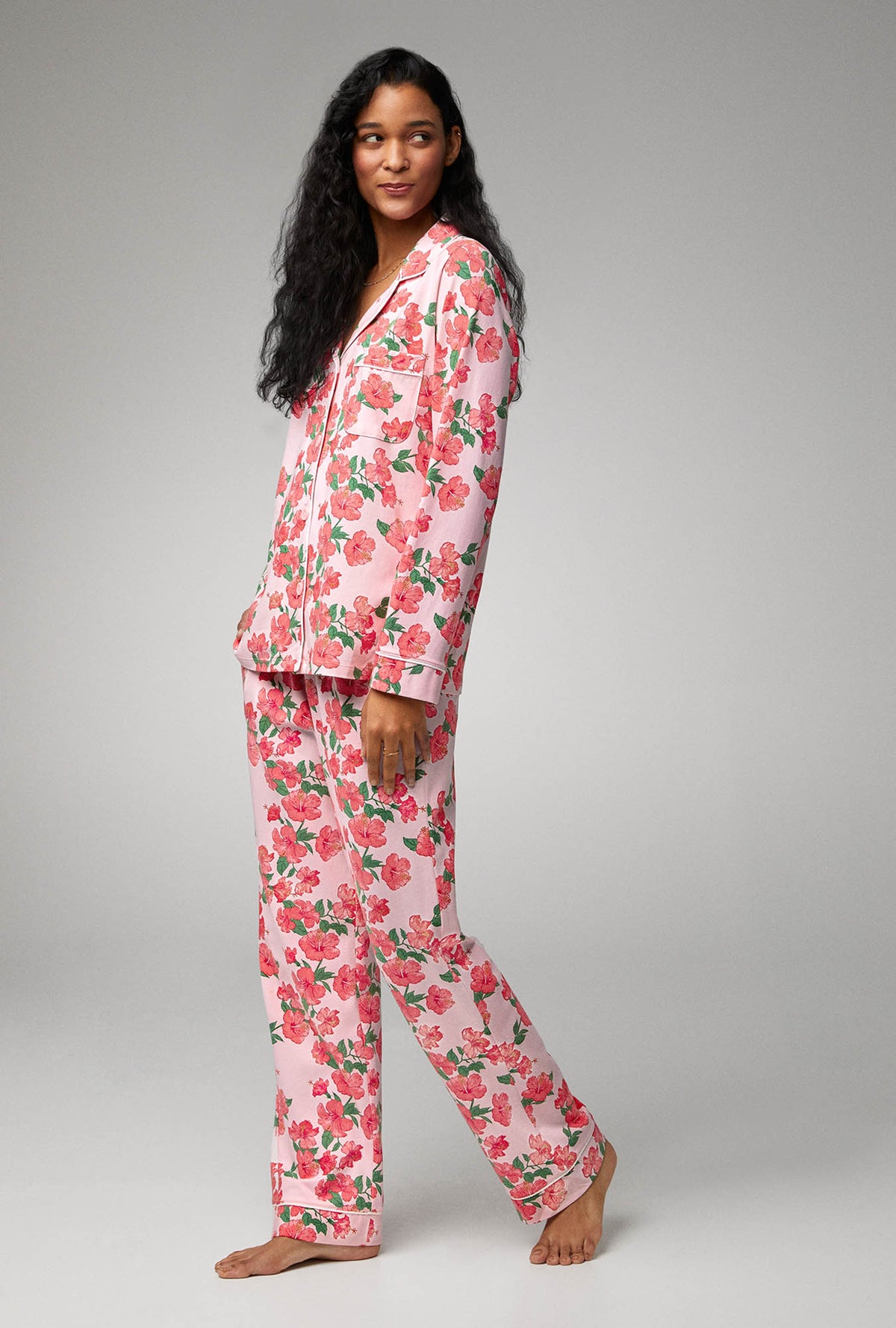 A lady wearing pink long sleeve classic stretch jersey pj set with sweer hibisus.