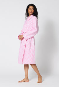 A Lady Wearing Pink Signature Stripe Lined Woven Cotton Sateen Robe facing front while looking to the side