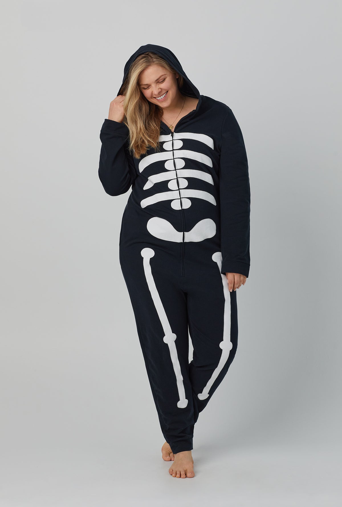 A lady wearing unisex long sleeve french terry onesie with skeleton print