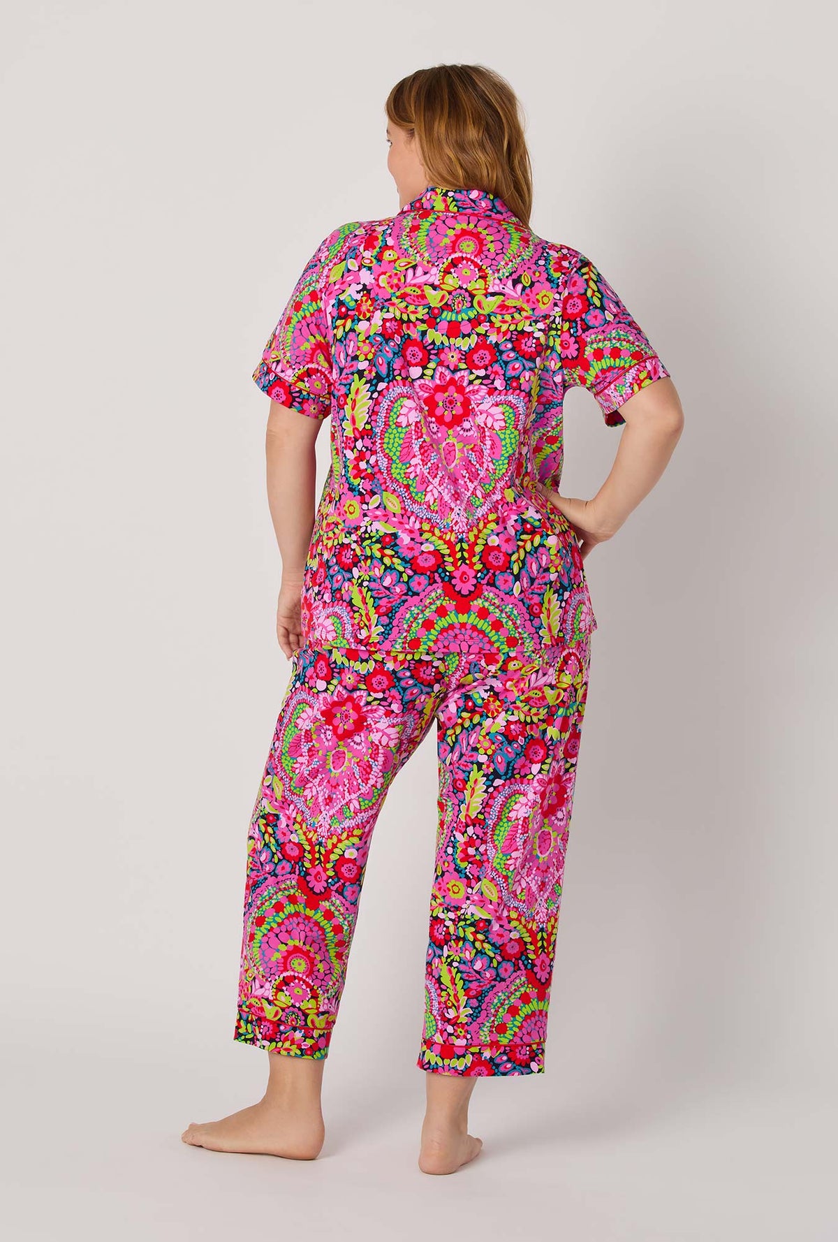 A lady wearing BedHead x Trina Turk Las Flores Short Sleeve Classic Stretch Jersey Cropped Pj Set