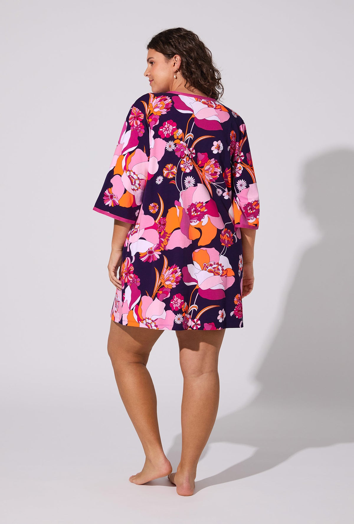 A lady wearing BedHead X Trina Turk Floral Medley 3/4 Sleeve Stretch Jersey Caftan