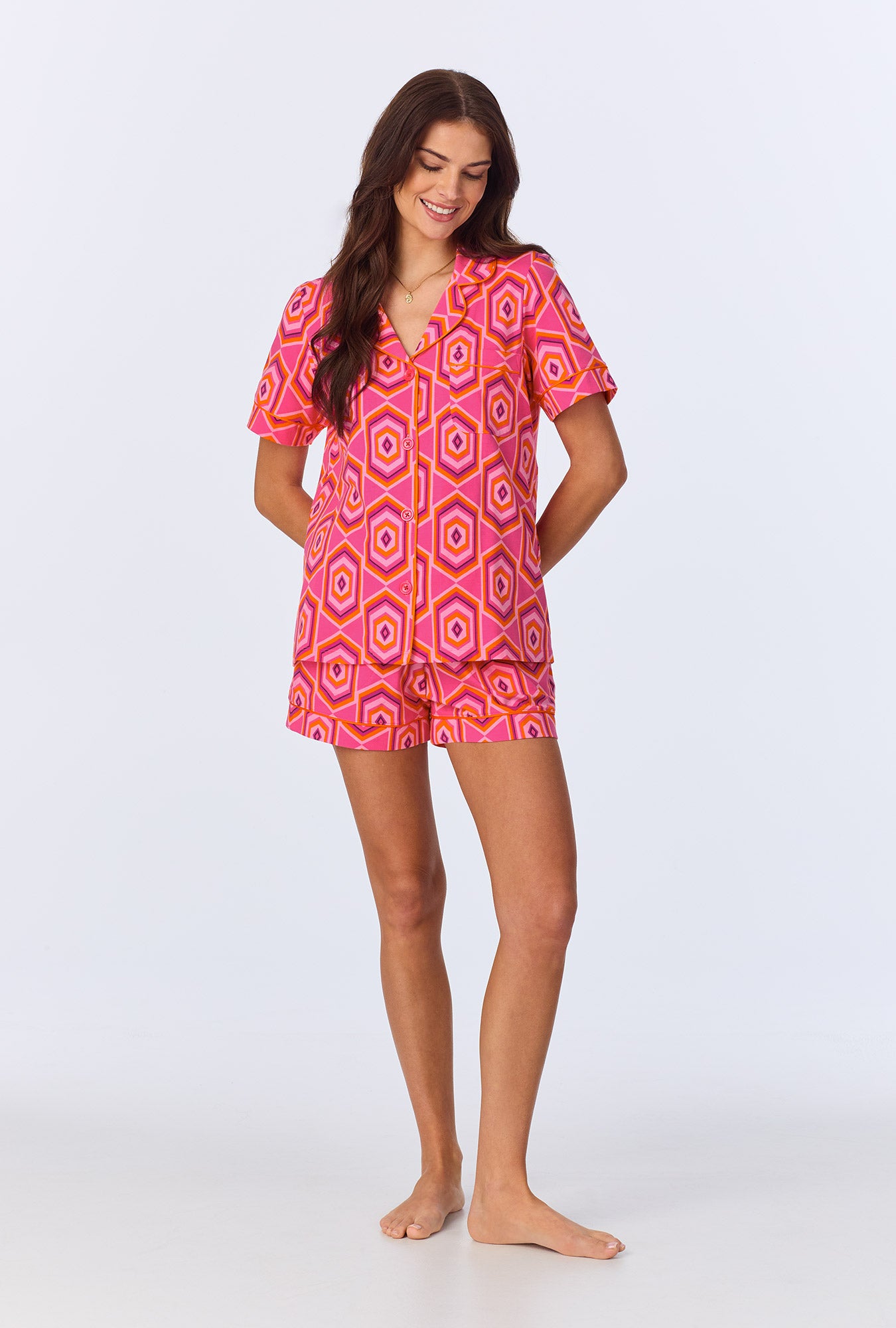 A lady wearing BedHead x Trina Turk Multi Hexagon Sleeve Classic Shorty Stretch Jersey PJ Set