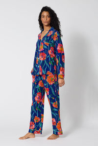 A Lady Wearing BedHead x Trina Turk Linear Poppy Long Sleeve Classic Stretch Jersey Pj Set in a side angled pose